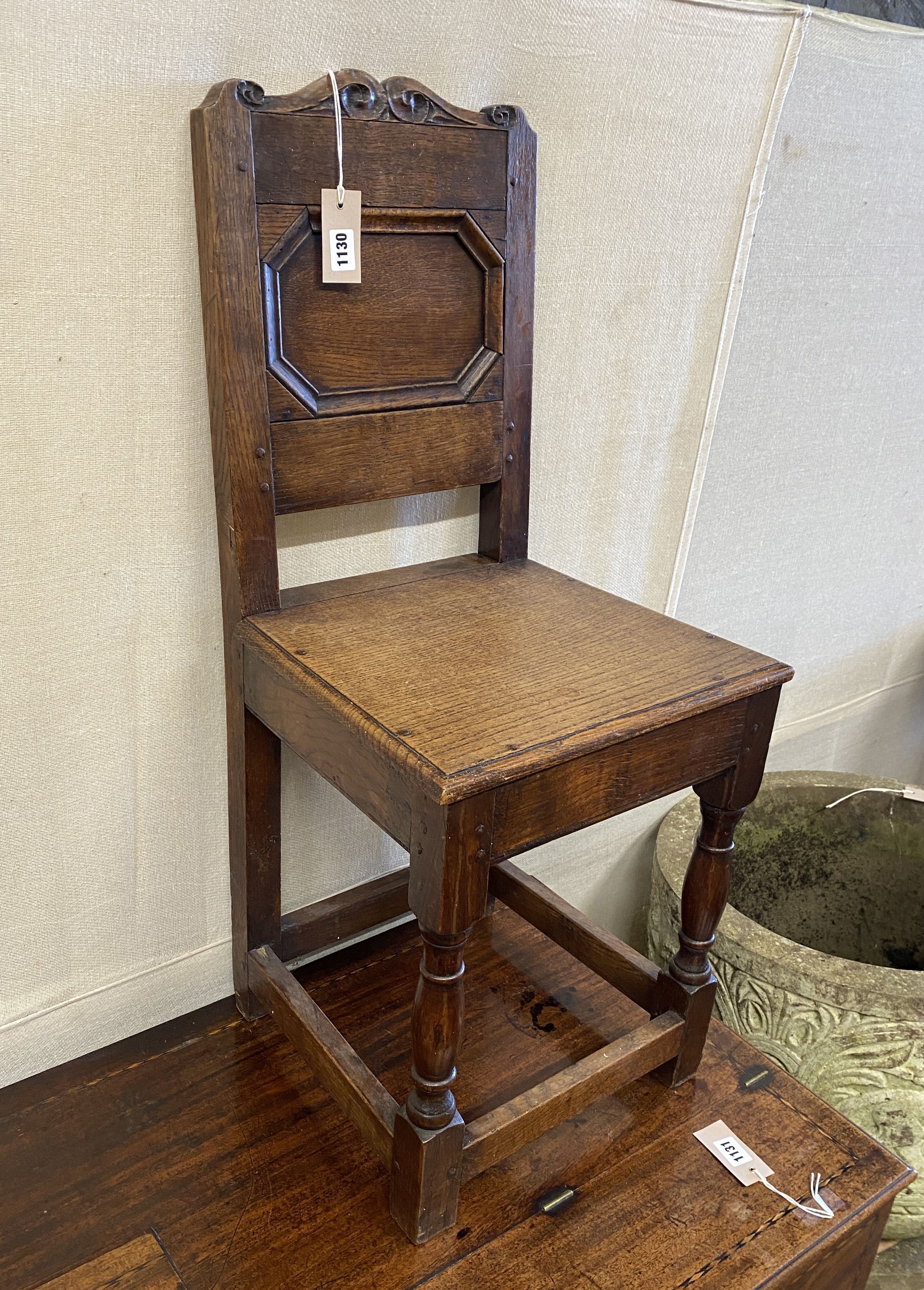 An 18th century and later oak back stool